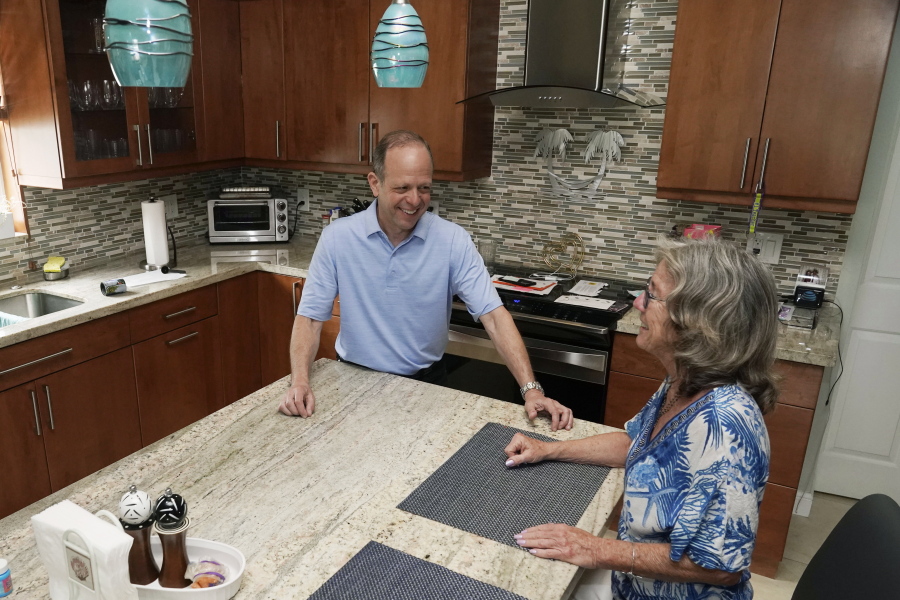 Mark Bendell and his wife Laurie talk in their kitchen, Monday, May 23, 2022, in Boca Raton, Fla. A stock market slump this year, which has taken big bites out of investors' portfolios, including retirement plans like 401(k)s, is worrying Americans who are within a few years of retirement.