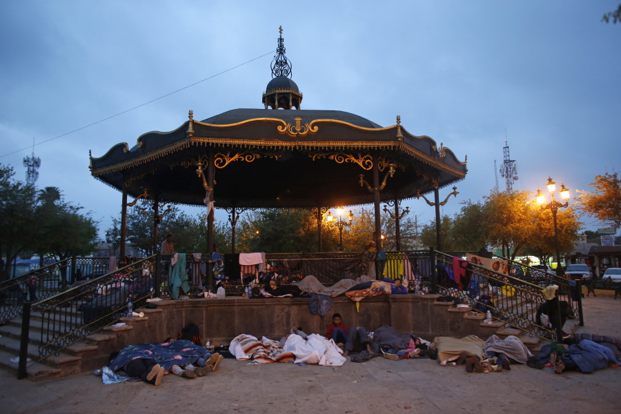 FILE - Migrants sleep under a gazebo at a park in Reynosa, Mexico, March 27, 2021. The camp of migrants mainly from Guatemala, El Salvador, Honduras and Haiti sprung up after U.S. officials. citing the pandemic, invoked a a health rule that denies migrants a chance to seek asylum.