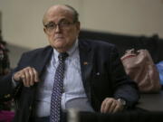Former New York City Mayor Rudy Giuliani sits where delegate votes will be counted as nominee for statewide positions are introduced during the Michigan Republican convention at Devos Place in Grand Rapids, Mich., on Saturday, April 23, 2022.