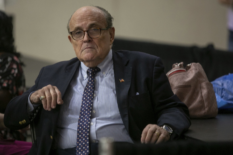 Former New York City Mayor Rudy Giuliani sits where delegate votes will be counted as nominee for statewide positions are introduced during the Michigan Republican convention at Devos Place in Grand Rapids, Mich., on Saturday, April 23, 2022.