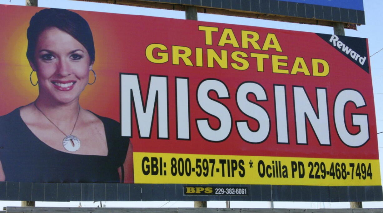 FILE - An image of Tara Grinstead is displayed on a billboard in Ocilla, Ga. Ryan Duke, charged with murdering Grinstead, a popular high school teacher who vanished in 2005, went on trial Monday, May 9, 2022, with prosecutors and defense attorneys clashing over whether the jury should believe the defendant's confession to investigators.