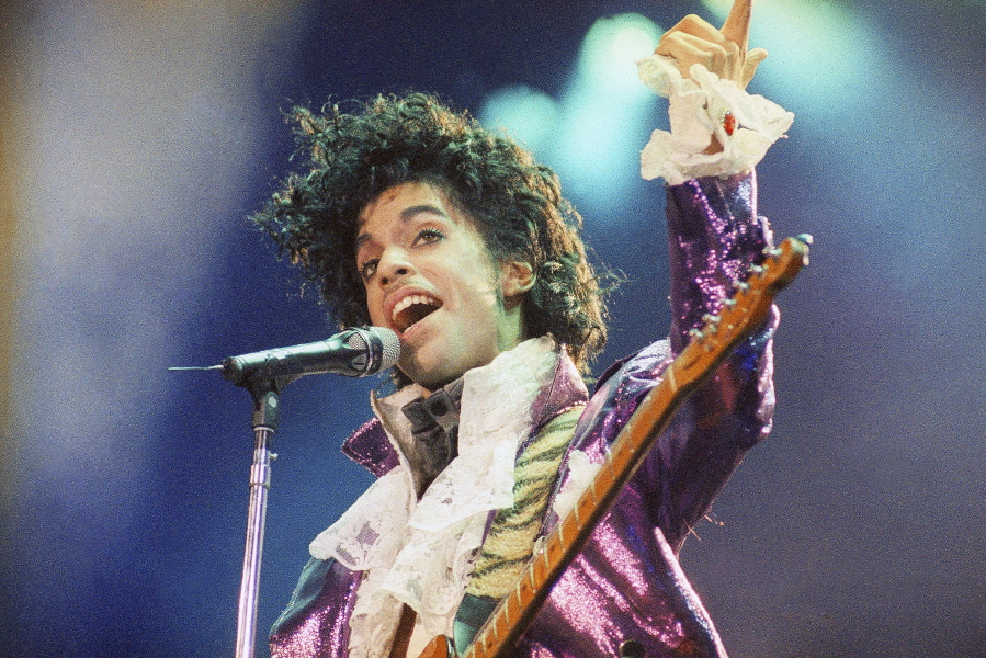 FILE - Prince performs at the Forum in Inglewood, Calif., on  Feb. 18, 1985. A reworked and re-released concert that captures Prince & The Revolution at their peak is coming next month.  Prince and The Revolution: Live" will be released June 3 in a variety of formats, including digital streaming platforms, a three-LP vinyl version, a two-CD version and a Blu-ray of the concert film.