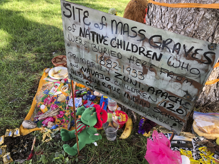 FILE - A makeshift memorial for the dozens of Indigenous children who died more than a century ago while attending a boarding school that was once located nearby is displayed under a tree at a public park in Albuquerque, N.M., on  July 1, 2021. The U.S. Interior Department is expected to release a report Wednesday, May 11, 2022, that it says will begin to uncover the truth about the federal government's past oversight of Native American boarding schools.