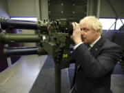 Britain's Prime Minister Boris Johnson with a Mark 3 shoulder launch LML (Lightweight Multiple Launcher) missile system, at Thales weapons manufacturer in Belfast, Monday May 16, 2022, during a visit to Northern Ireland. Johnson said there would be "a necessity to act" if the EU doesn't agree to overhaul post-Brexit trade rules that he says are destabilizing Northern Ireland's delicate political balance. Johnson held private talks with the leaders of Northern Ireland's main political parties, urging them to get back to work.
