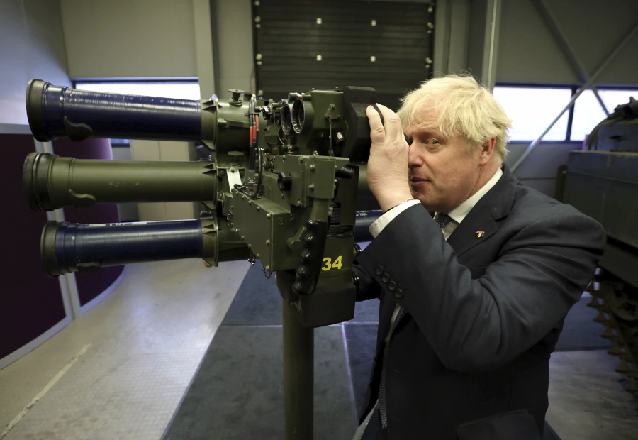 Britain's Prime Minister Boris Johnson with a Mark 3 shoulder launch LML (Lightweight Multiple Launcher) missile system, at Thales weapons manufacturer in Belfast, Monday May 16, 2022, during a visit to Northern Ireland. Johnson said there would be "a necessity to act" if the EU doesn't agree to overhaul post-Brexit trade rules that he says are destabilizing Northern Ireland's delicate political balance. Johnson held private talks with the leaders of Northern Ireland's main political parties, urging them to get back to work.