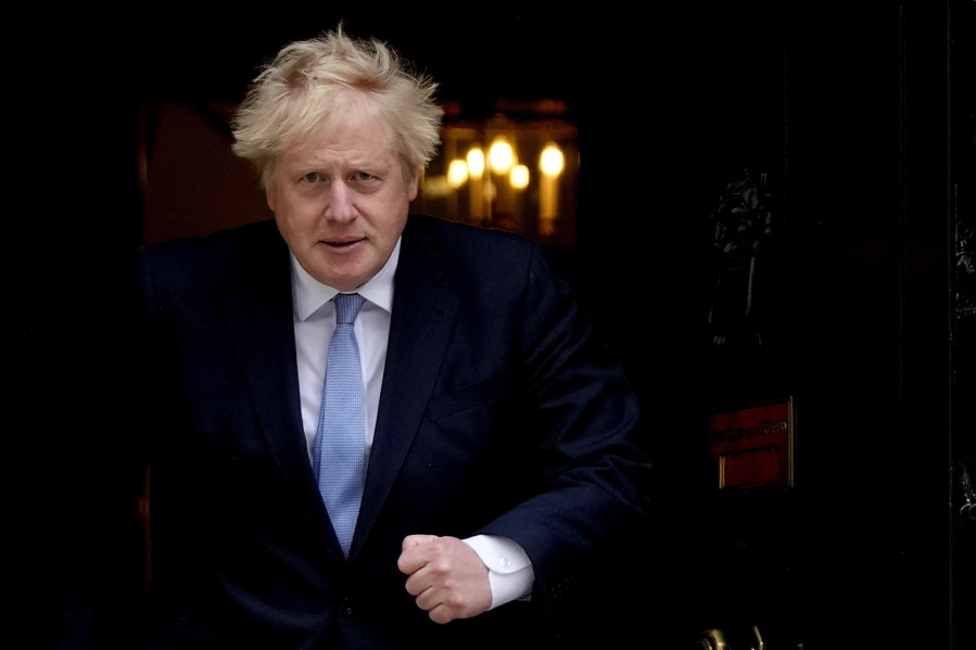FILE - Britain's Prime Minister Boris Johnson walks out the door to meet Norwegian Prime Minister Jonas Gahr Store at 10 Downing Street in London, Friday, May 13, 2022. Johnson is heading to Northern Ireland on Monday, May 16, 2022 to try to end a political deadlock that is preventing the formation of a regional administration.