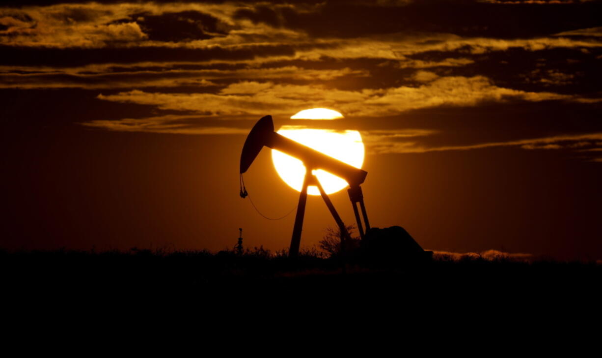 FILE - The sun sets behind an idle pump jack near Karnes City, USA, April 8, 2020.  Oil markets have been fluctuating over fears of lost supplies from Russia because of the war in Ukraine. But the alliance of OPEC members and allied oil-producing countries are likely to steer a steady course when they decide production levels at an online meeting Thursday. The OPEC+ alliance has been opening the taps only gradually to restore cuts made during the worst of the pandemic recession.