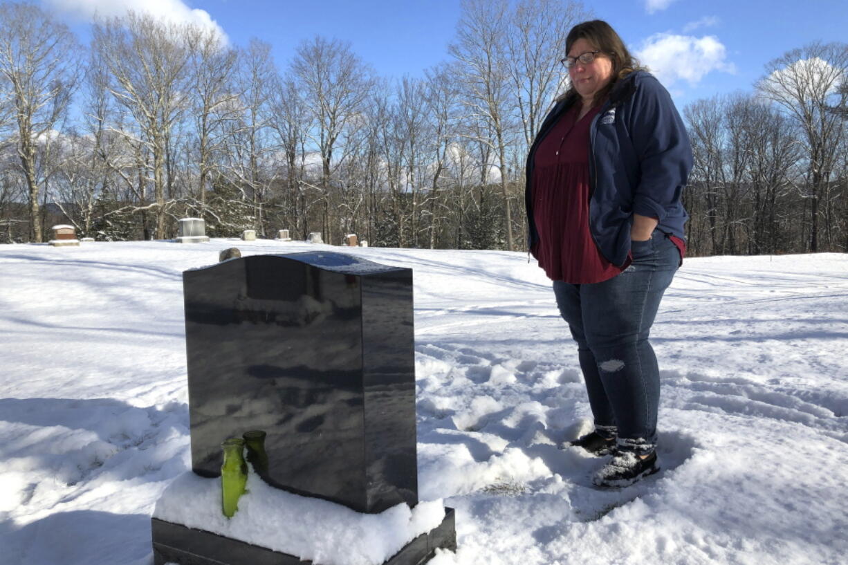 FILE - Deb Walker visits the grave of her daughter, Brooke Goodwin, Thursday, Dec. 9, 2021, in Chester, Vt. Goodwin, 23, died in March of 2021 of a fatal overdose of the powerful opioid fentanyl and xylazine, an animal tranquilizer that is making its way into the illicit drug supply. According to provisional data released by the Centers for Disease Control and Prevention on Wednesday, May 11, 2022, more than 107,000 Americans died of drug overdoses in 2021, setting another tragic record in the nation's escalating overdose epidemic.