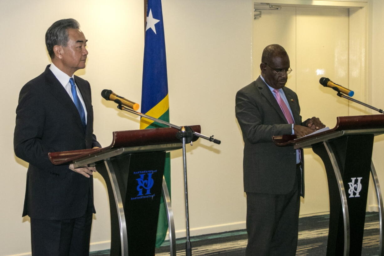 China's Foreign Minister Wang Yi, left, and his counterpart from the Solomon Islands, Jeremiah Manele hold a joint news conference in Honiara, Solomon Islands, early Thursday, May 26, 2022. Wang and a 20-strong delegation have arrived in the Solomon Islands at the start of an eight-nation Pacific tour that comes amid growing concerns about Beijing's military and financial ambitions in the region.
