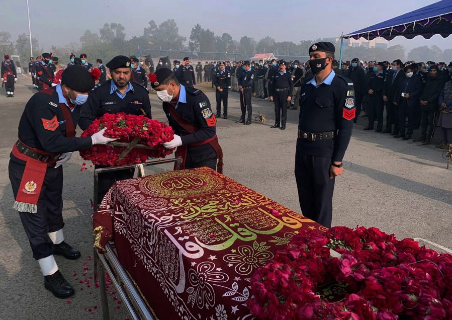 FILE- Police officers attend the funeral prayer of a colleague who was killed in an overnight attack by Pakistani Taliban who targeted police in multiple attacks in Islamabad and elsewhere in the country's northwest, in Islamabad, Pakistan, Jan. 18, 2022. Faced with rising violence, Pakistan is taking a tougher line to pressure Afghanistan's Taliban rulers to crack down on militants hiding on their soil, but so far the Taliban remain reluctant to take action -- trying instead to broker a peace.