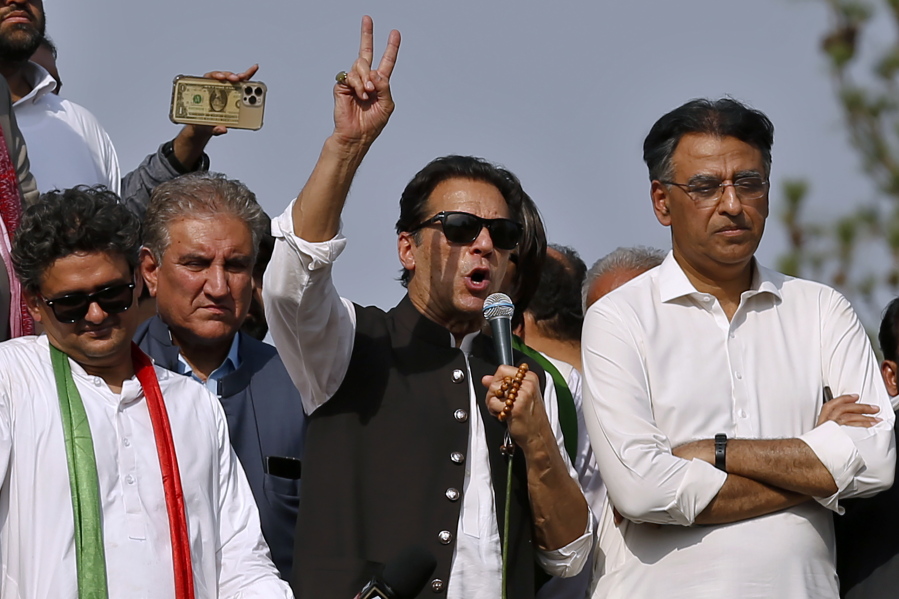 Supporters of Pakistan's defiant former Prime Minister Imran Khan, center, addresses during an anti government rally, in Islamabad, Pakistan, Thursday, May 26, 2022. Khan early Thursday warned Pakistan's government to set new elections in the next six days or he will again march on the capital along with 3 million people.