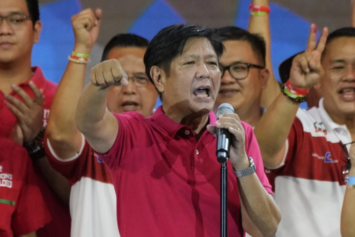 FILE - Presidential hopeful, former senator Ferdinand "Bongbong" Marcos Jr., the son of the late dictator, gestures as he greets the crowd during a campaign rally in Quezon City, Philippines on April 13, 2022. Marcos Jr.'s apparent landslide victory in the Philippine presidential election is giving rise to immediate concerns about a further erosion of democracy in the region, and could complicate American efforts to blunt growing Chinese influence and power in the Pacific.