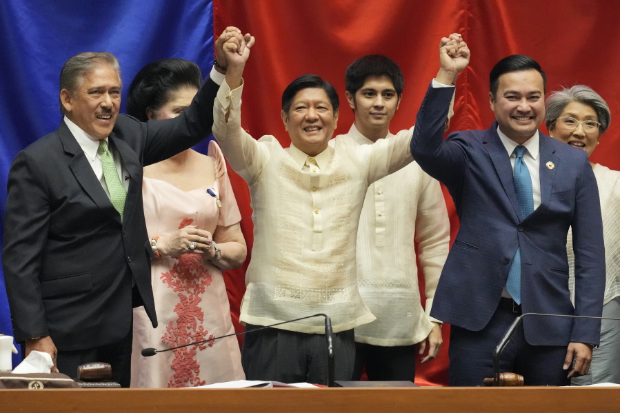 President-elect Ferdinand "Bong" Marcos Jr., center, raises hands with Senate President Vicente Sotto III, left, and House Speaker Lord Allan Velasco during his proclamation at the House of Representatives, Quezon City, Philippines on Wednesday, May 25, 2022. Marcos Jr. was proclaimed the next president of the Philippines by a joint session of Congress Wednesday in an astonishingly huge electoral triumph 36 years after his father was ousted as a brutal dictator by a pro-democracy uprising.