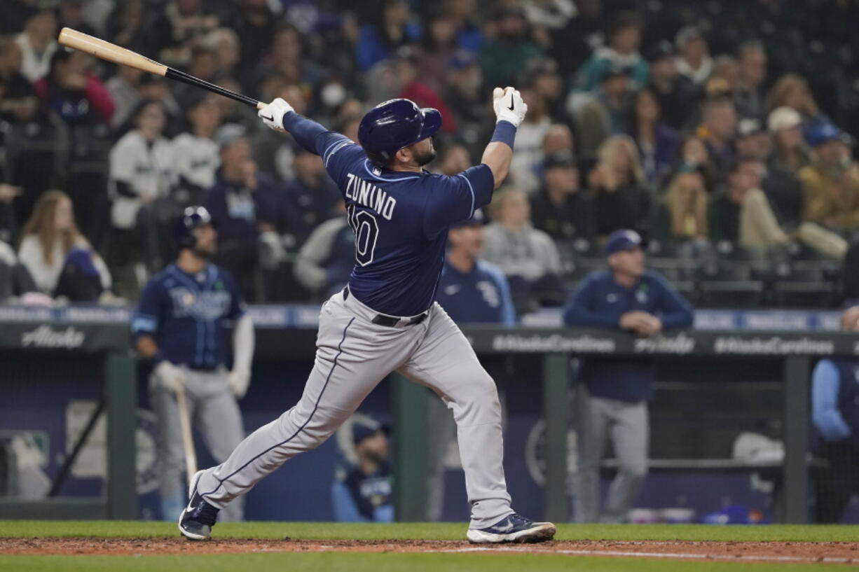 Tampa Bay Rays' Mike Zunino follows through on a three-run home run during the fourth inning of the team's baseball game against the Seattle Mariners, Thursday, May 5, 2022, in Seattle. (AP Photo/Ted S.