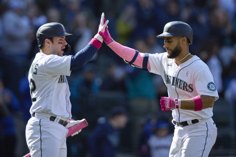 Seattle Mariners' Abraham Toro, right, is greeted at home plate by Luis Torrens after hitting a solo home run against the Tampa Bay Rays during the ninth inning of a baseball game, Sunday, May 8, 2022, in Seattle.