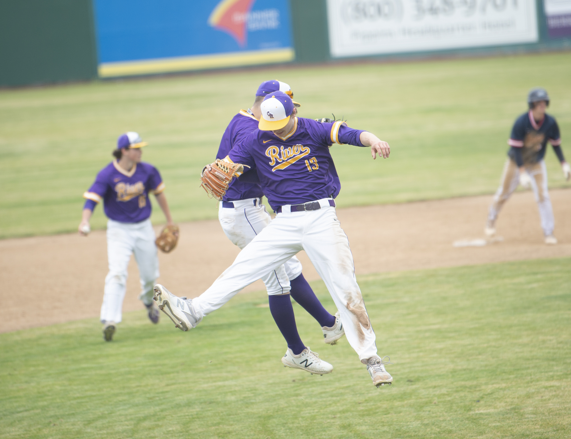 Columbia River's Sam Boyle (13) bumps Chris Parkin in celebration after the Rapids' 1-0 win over Ellensburg in the 2A state baseball semifinal at Yakima County Stadium on Friday, May 27, 2022.