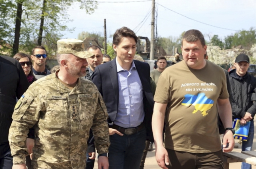This image provided by the Irpin Mayor's Office shows Canadian Prime Minister Justin Trudeau walking with mayor Oleksandr Markushyn, right, in Irpin, Ukraine, Sunday, May 8, 2022. Trudeau made a surprise visit to Irpin on Sunday. The city was severely damaged during Russia's attempt to take Kyiv at the start of the war.