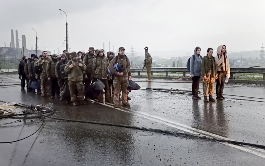 In this photo taken from video released by the Russian Defense Ministry on Thursday, May 19, 2022, shows Ukrainian servicemen as they leave the besieged Azovstal steel plant in Mariupol, in territory under the government of the Donetsk People's Republic, eastern Ukraine.