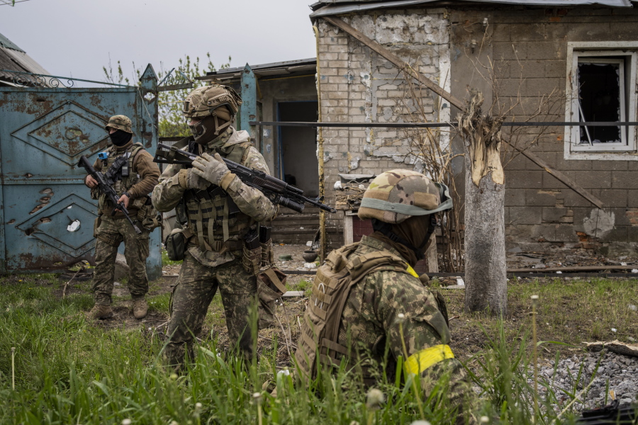 Ukrainian National Guard patrol during a reconnaissance mission in a recently retaken village on the outskirts of Kharkiv, east Ukraine, Saturday, May 14, 2022.