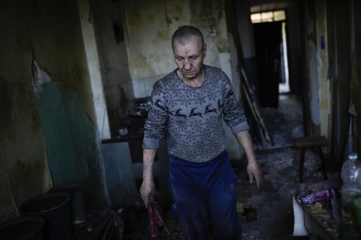 A local resident gathers belongings from his heavily damaged house after a Russian strike in Pokrovsk, eastern Ukraine, Wednesday, May 25, 2022. Two rockets struck the eastern Ukrainian town of Pokrovsk, in the Donetsk region early Wednesday morning, causing at least four injuries.