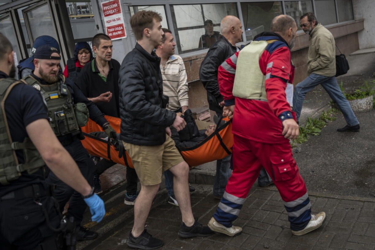 An injured man as a result of shelling is carried on a stretcher in Kharkiv, eastern Ukraine, Thursday, May 26, 2022.