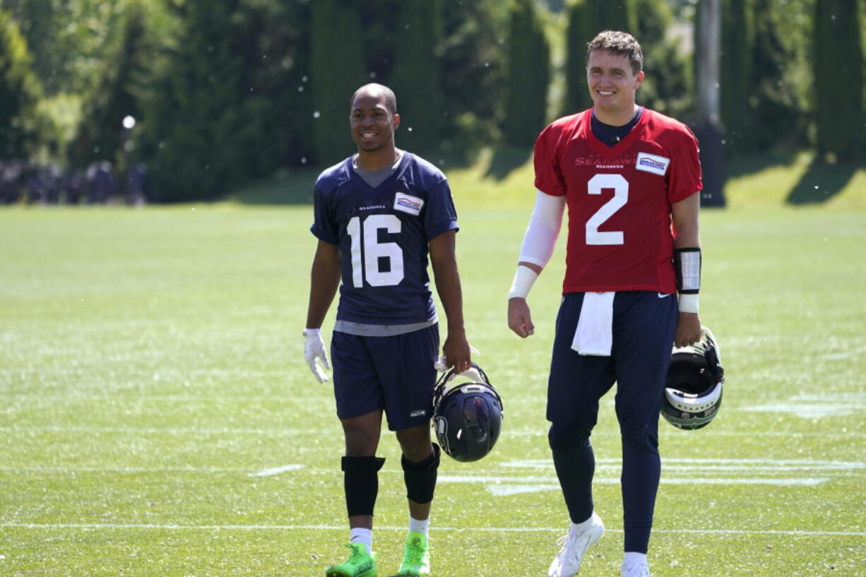 Seattle Seahawks quarterback Drew Lock, right, walks with Tyler Lockett after practice Tuesday in Renton. (Ted S.