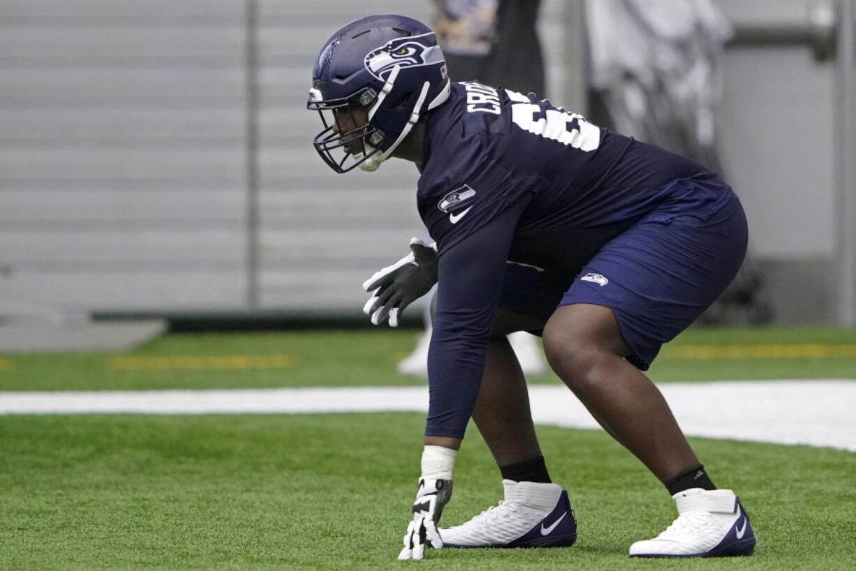 Seattle Seahawks offensive tackle Charles Cross gets set in a three-point stance during NFL football rookie minicamp Friday, May 6, 2022, in Renton, Wash. (AP Photo/Ted S.