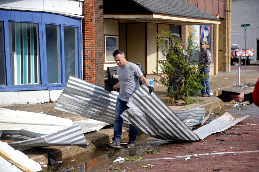 Tony Dowdy, of Victory Family Church, helps clean up tornado damage in Seminole, Okla. on Thursday, May, 5, 2022. A springtime storm system spawned several tornadoes that whipped through areas of Texas and Oklahoma, causing damage to a school, a marijuana farm and other structures.