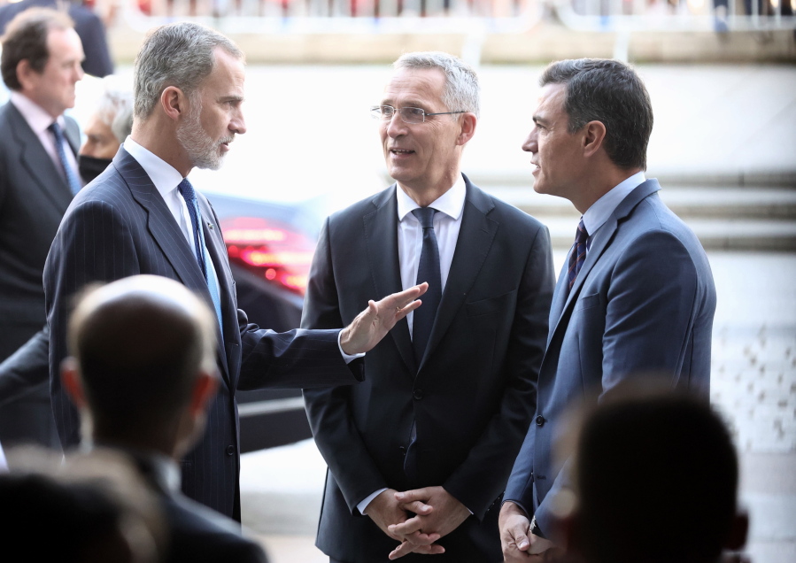 Spain's King Felipe VI speaks with NATO Secretary General Jens Stoltenberg, centre, and Spanish Prime Minister Pedro S?nchez, right, as they attend a gala at Madrid's Royal Theater, Monday, May 30, 2022. Stoltenberg visits Madrid for Spain's celebration of its 40th year as part of the military alliance one month before the capital hosts an important NATO summit.