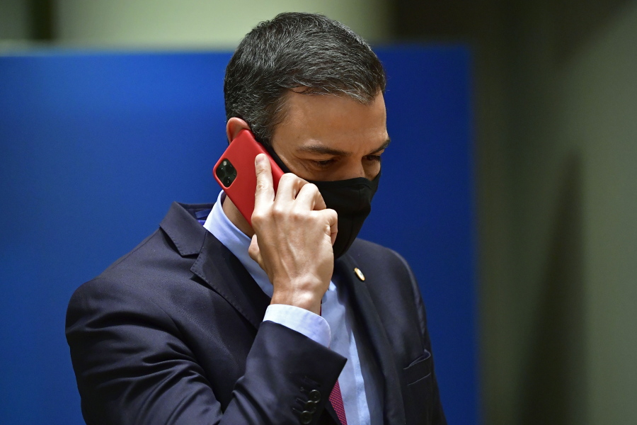 FILE - Spain's Prime Minister Pedro Sanchez speaks on his cell phone during a round table meeting at an EU summit in Brussels, Monday, July 20, 2020. Spanish officials said on Monday May 2, 2022 that the cellphones of the prime minister and the defense minister were infected with Pegasus spyware that is only available to government agencies, in an operation that was not authorised by the government. Reports detailing the breaches have been transferred to Spain's National Court for further investigation.
