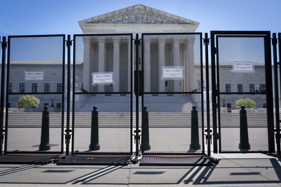 FILE - Anti-scaling fencing blocks off the Supreme Court, May 10, 2022, in Washington.