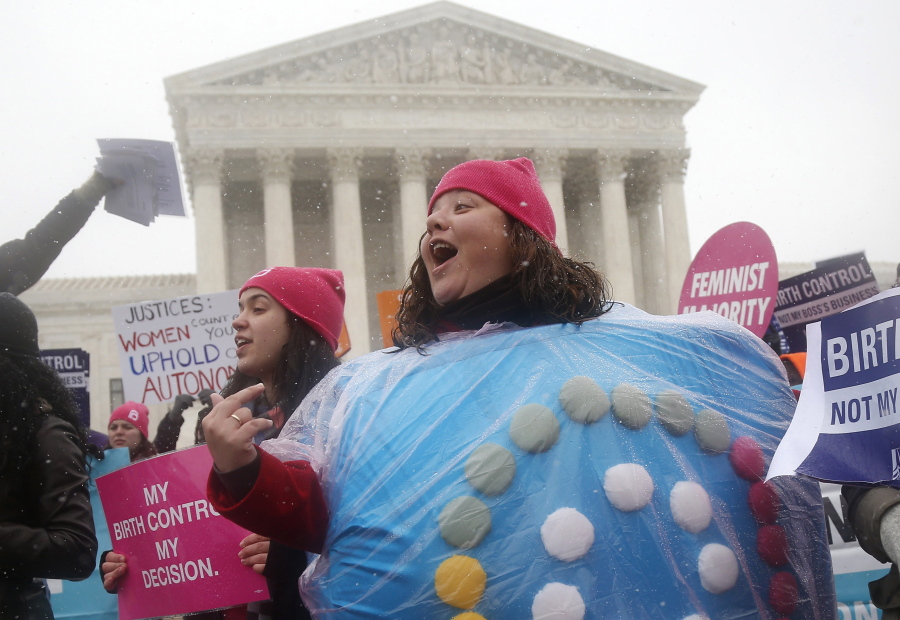 FILE - Margot Riphagen of New Orleans, wears a birth control pill costume as she protests in front of the Supreme Court in Washington on March 25, 2014. In 2022, a leaked draft opinion indicating U.S. Supreme Court justices are poised to overturn the decision that legalized abortion nationwide in the U.S. is raising fears that restrictions on contraception could follow.