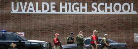Law enforcement personnel walk outside Uvalde High School after shooting a was reported earlier in the day at Robb Elementary School, Tuesday, May 24, 2022, in Uvalde, Texas.