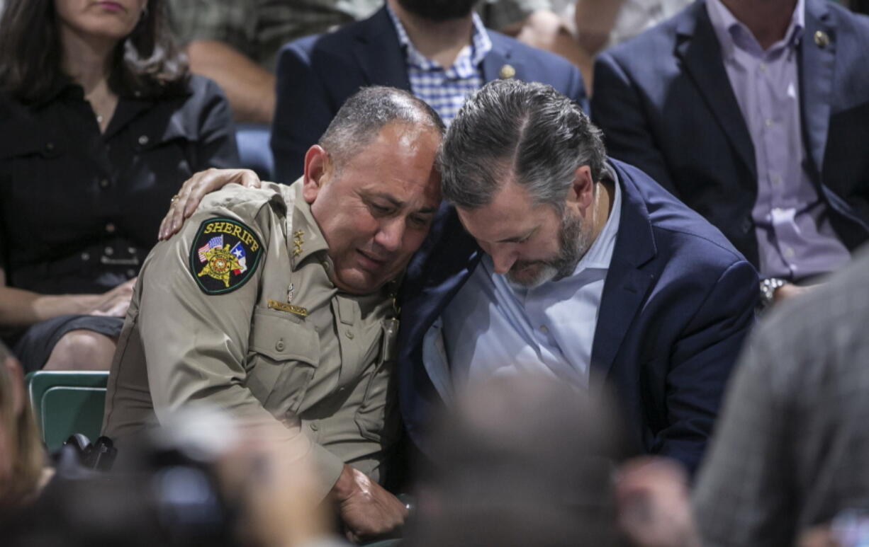 Uvalde County Sheriff Ruben Nolasco, left, is comforted by U.S. Sen. Ted Cruz during a vigil held in honor of the lives lost at Robb Elementary school at the Uvalde County Fairplex Arena in Uvalde, Texas, Wednesday, May 25, 2022.
