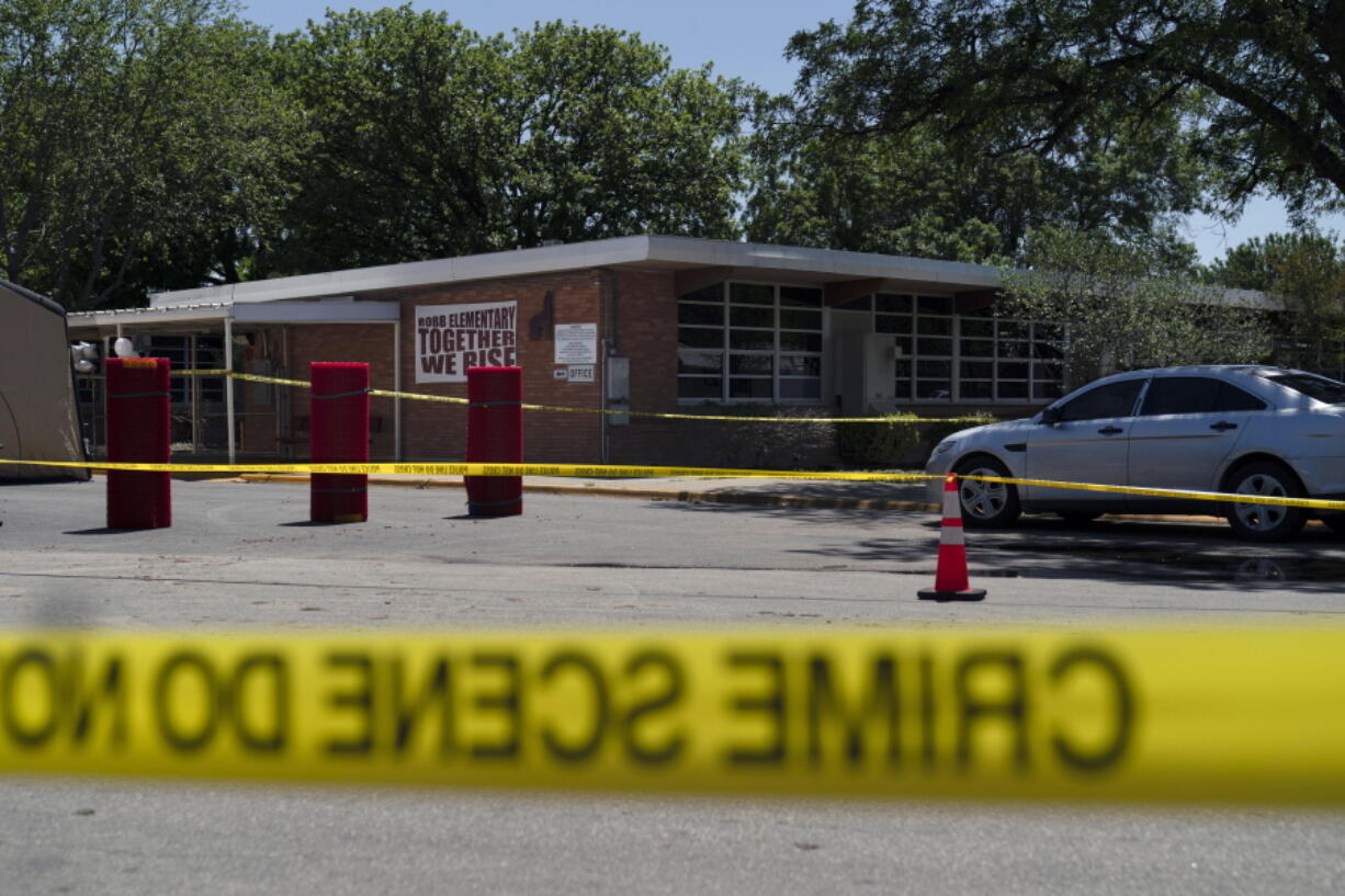Crime scene tape surrounds Robb Elementary School in Uvalde, Texas, Wednesday, May 25, 2022. Desperation turned to heart-wrenching sorrow for families of grade schoolers killed after an 18-year-old gunman barricaded himself in their Texas classroom and began shooting, killing at least 19 fourth-graders and their two teachers. (AP Photo/Jae C.