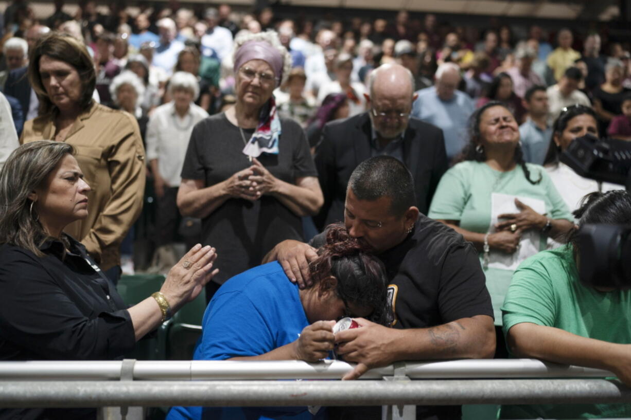 Two family members of one of the victims killed in Tuesday's shooting at Robb Elementary School comfort each other during a prayer vigil in Uvalde, Texas, Wednesday, May 25, 2022. (AP Photo/Jae C.
