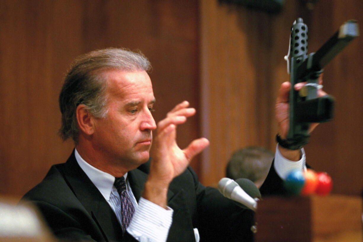 FILE - Sen. Joe Biden, D-Del., chairman of the Senate Judiciary Committee, holds a TEC-9 semi-automatic weapon during a hearing of the committee on Capitol Hill, Aug. 3, 1993, as the committee holds hearings on combating the proliferation of assault weapons.