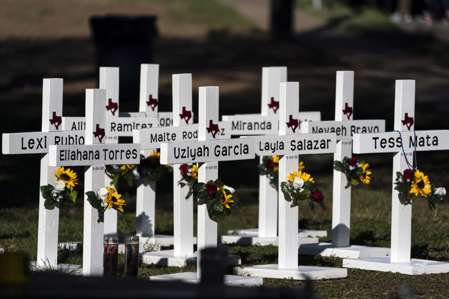 Crosses with the names of Tuesday's shooting victims are placed outside Robb Elementary School in Uvalde, Texas, Thursday, May 26, 2022. The 18-year-old man who slaughtered 19 children and two teachers in Texas left a digital trail that hinted at what was to come.  (AP Photo/Jae C.