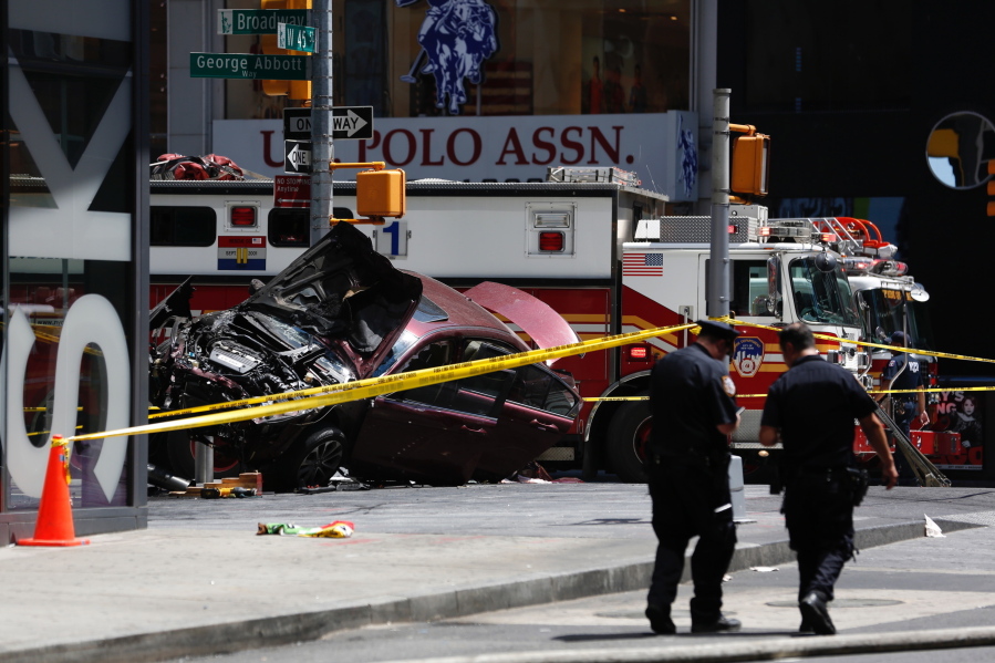 FILE- A smashed car sits on the corner of Broadway and 45th Street in New York's Times Square after several were injured when the car was driven into a crowd of pedestrians on May 18, 2017.