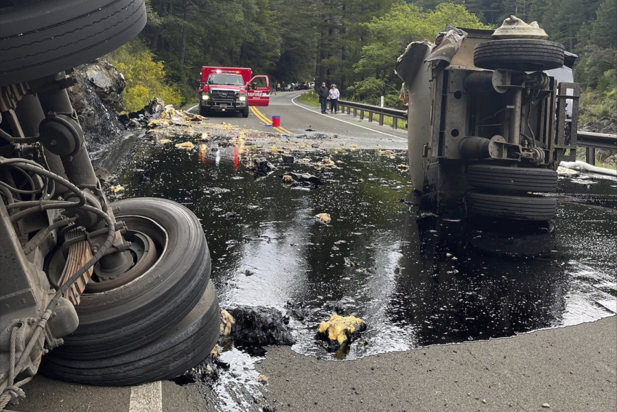 This Tuesday, April 29, 2022 photo released by the U.S. Forest Service - Six Rivers National Forest shows a semi-truck that had a damaged tire as it traveled on State Route 199 in Del Norte County near Gasquet, Calif. The truck crashed on a remote highway spilled 2,000 gallons of hot asphalt binder in a Northern California forest near Gasquet, Calif. The driver was arrested on suspicion of DUI. The trailer eventually overturned, spilling hot asphalt binder, which began seeping into the Smith River. Del Norte County Office of Emergency Services says there is no impact to water quality. (U.S.