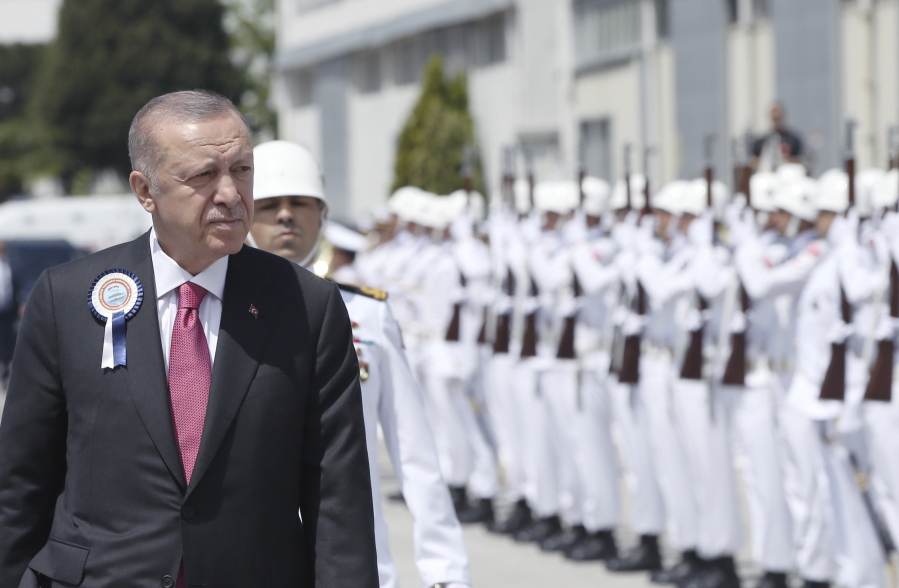 Turkish President Recep Tayyip Erdogan inspects a military honour guard during a ceremony marking the docking of a submarine, in Kocaeli, Turkey, Monday, May 23, 2022. Erdogan, whose country has objected to Sweden and Finland joining NATO, called on Stockholm on Monday to take "concrete steps" that would alleviate Turkey's security concerns.
