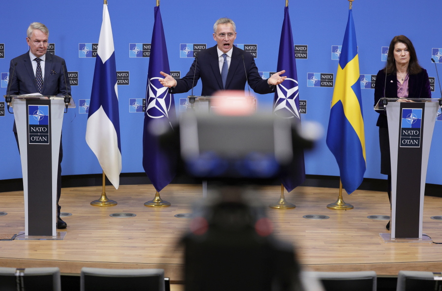 FILE - NATO Secretary General Jens Stoltenberg, center, participates in a media conference with Finland's Foreign Minister Pekka Haavisto, left, and Sweden's Foreign Minister Ann Linde, right, at NATO headquarters in Brussels, Monday, Jan. 24, 2022.