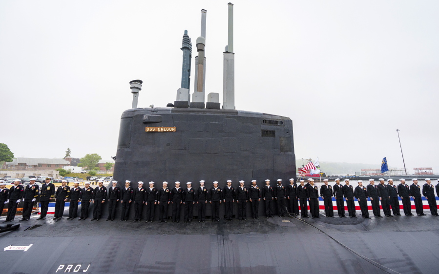 Crew members line up along the USS Oregon during the submarine's commissioning ceremony Saturday, May 28, 2022, in Groton, Conn. The newest Virginia-class fast attack submarine, which can dive to depths greater than 800 feet (240 meters), was originally christened in 2019. But the COVID-19 pandemic created some "slips in schedule" for the crew, said Rep. Joe Courtney, D-Conn., whose district includes General Dynamics Corp.'s Electric Boat Shipyard where the 377-foot (115-meter) submarine was constructed.