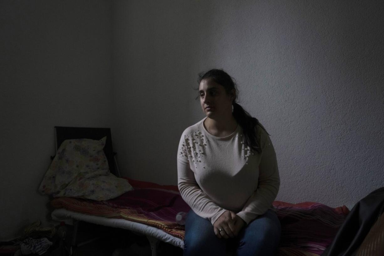 Victoria Dubovytska, survivor of the March 16, 2022, bombing of the Donetsk Academic Regional Drama Theatre in Mariupol, Ukraine, poses for a photo at a shelter in Lviv, western Ukraine, Thursday, March 31, 2022. When the bomb exploded, Dubovytska was in the projection room with her two children.
