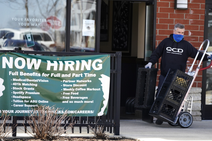 FILE - A hiring sign is displayed outside of a Starbucks in Schaumburg, Ill., Friday, April 1, 2022.  The number of Americans applying for jobless aid ticked up slightly last week but the total number of Americans collecting benefits remained at its lowest level in more than five decades. Applications for unemployment benefits rose by 1,000 to 203,000 for the week ending May 7, the Labor Department reported Thursday, May 12.  (AP Photo/Nam Y.