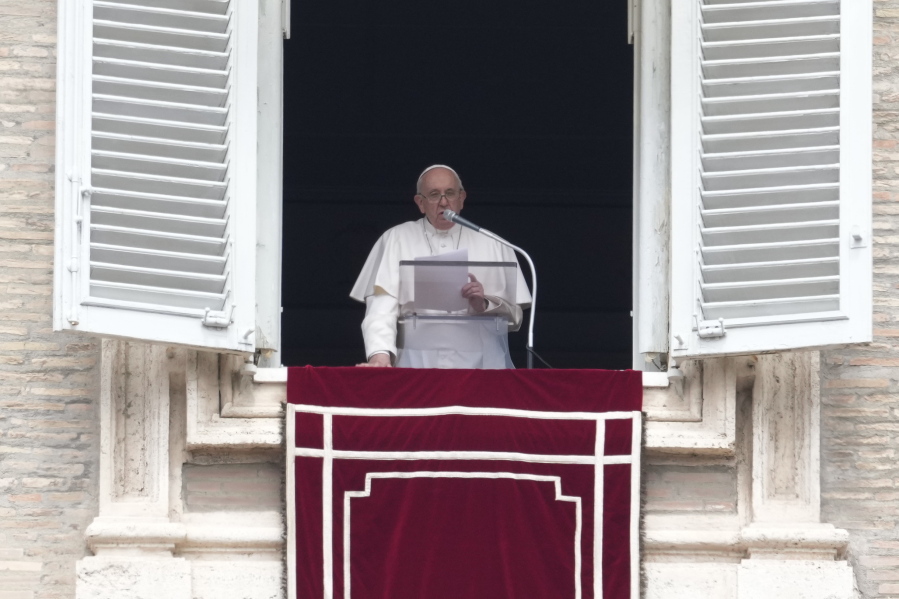 Pope Francis delivers his message from his studio window overlooking St. Peter's Square during the Regina Coeli prayer at the Vatican, Sunday, May 1, 2022.