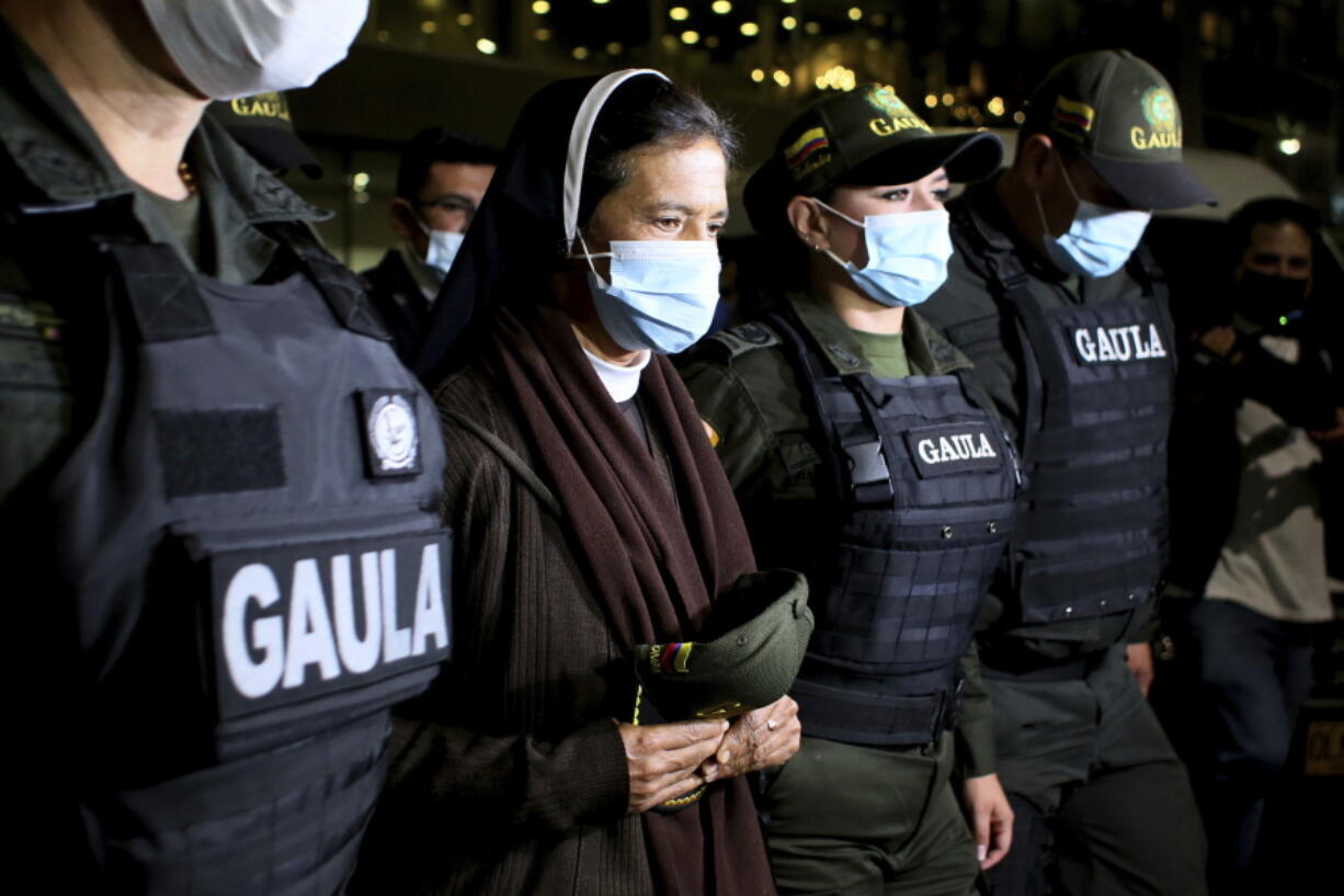 FILE -- Colombian nun Gloria Cecilia Narvaez, second from left, is escorted by police after her arrival at El Dorado airport in Bogota, Colombia, in this Tuesday, Nov. 16, 2021 file photo, after she was released on Oct. 10 by her kidnappers.