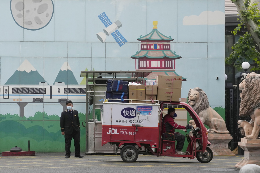 A delivery man past through the entrance to a community on Tuesday, May 10, 2022, in Beijing. China's capital began another round of three days of mass testing for millions of its residents Tuesday in a bid to prevent an outbreak from growing to Shanghai proportions.