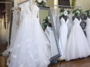 FILE - Wedding dresses are displayed at a bridal shop in East Dundee, Ill., on Feb. 28, 2020. Far fewer Americans were married during the first year of the COVID-19 pandemic, with the number of U.S. marriages in 2020 being the lowest recorded since 1963, according to statistics released by the Centers for Disease Control and Prevention on Tuesday, May 17, 2022.