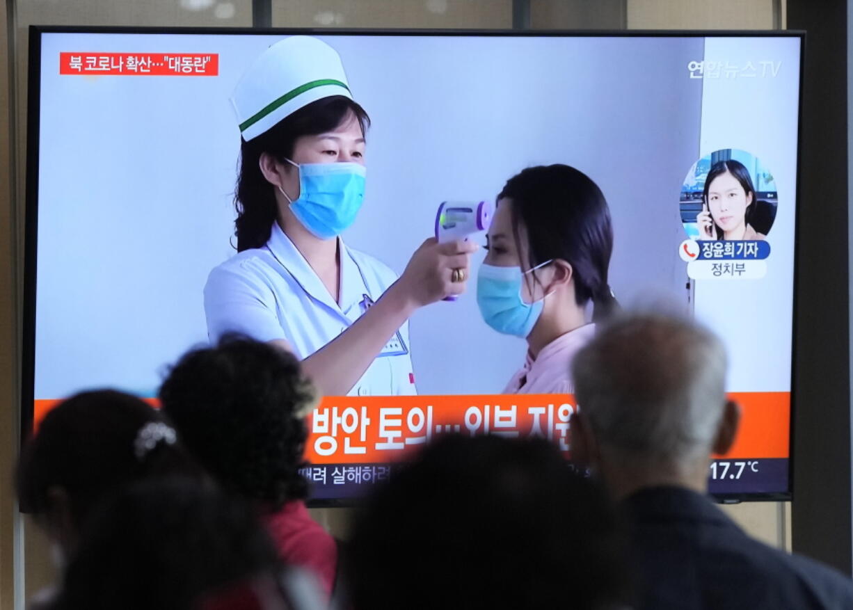 People watch a TV screen showing a news report about the COVID-19 outbreak in North Korea, at a train station in Seoul, South Korea, Saturday, May 14, 2022. North Korea on Saturday reported 21 new deaths and 174,440 more people with fever symptoms as the country scrambles to slow the spread of COVID-19 across its unvaccinated population.